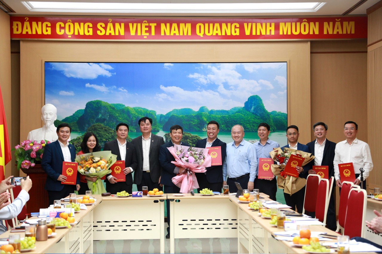 Thứ trưởng Bộ Tài chính Đỗ Thành Trung trao quyết định bổ nhiệm và tặng hoa chúc mừng các Phó Vụ trưởng Vụ Đầu tư. 